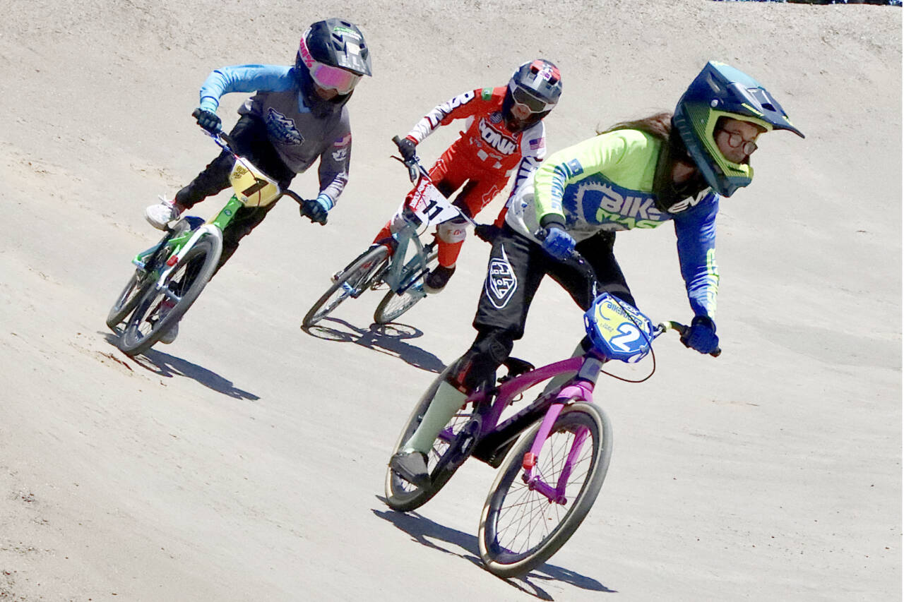 Lincoln Park BMX hosted a state-qualifying event Sunday, attracting 366 racers of all ages from all across Washington, trying to qualify for the state BMX championship scheduled at Lincoln Park BMX on Sept. 24. From left is Nyah Langdon of Port Angeles, Ava Burke of Gig Harbor and Makaylie Underwood of Port Angeles in the expert 12 girls moto. (Dave Logan/for Peninsula Daily News)