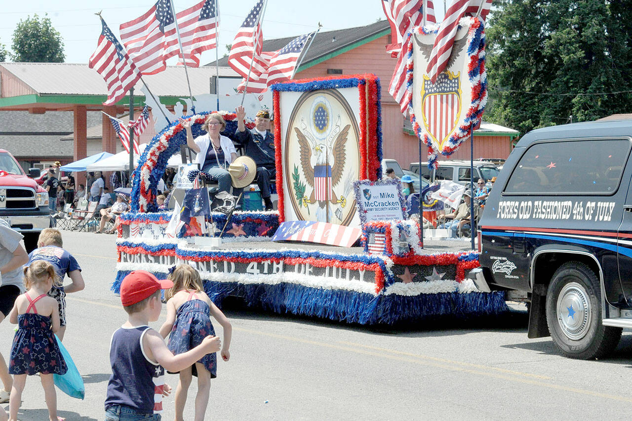 Honored Veteran Mike McCracken along with his wife Phemie on the Forks Fourth of July float during the Forks parade. (Lonnie Archibald/for Peninsula Daily News)