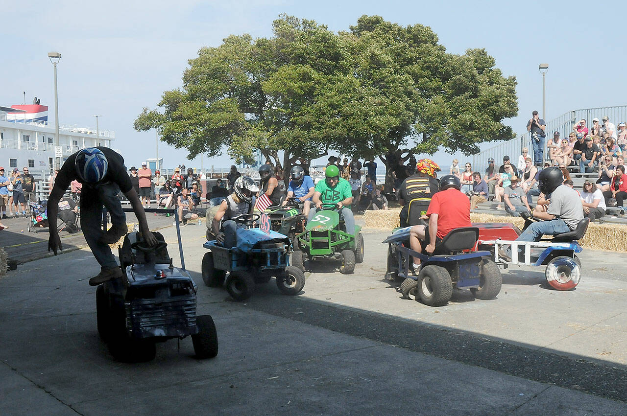 Participants in a lawnmower demolition derby crash into each other on Independence Day at Port Angeles City Pier. (Keith Thorpe/Peninsula Daily News)