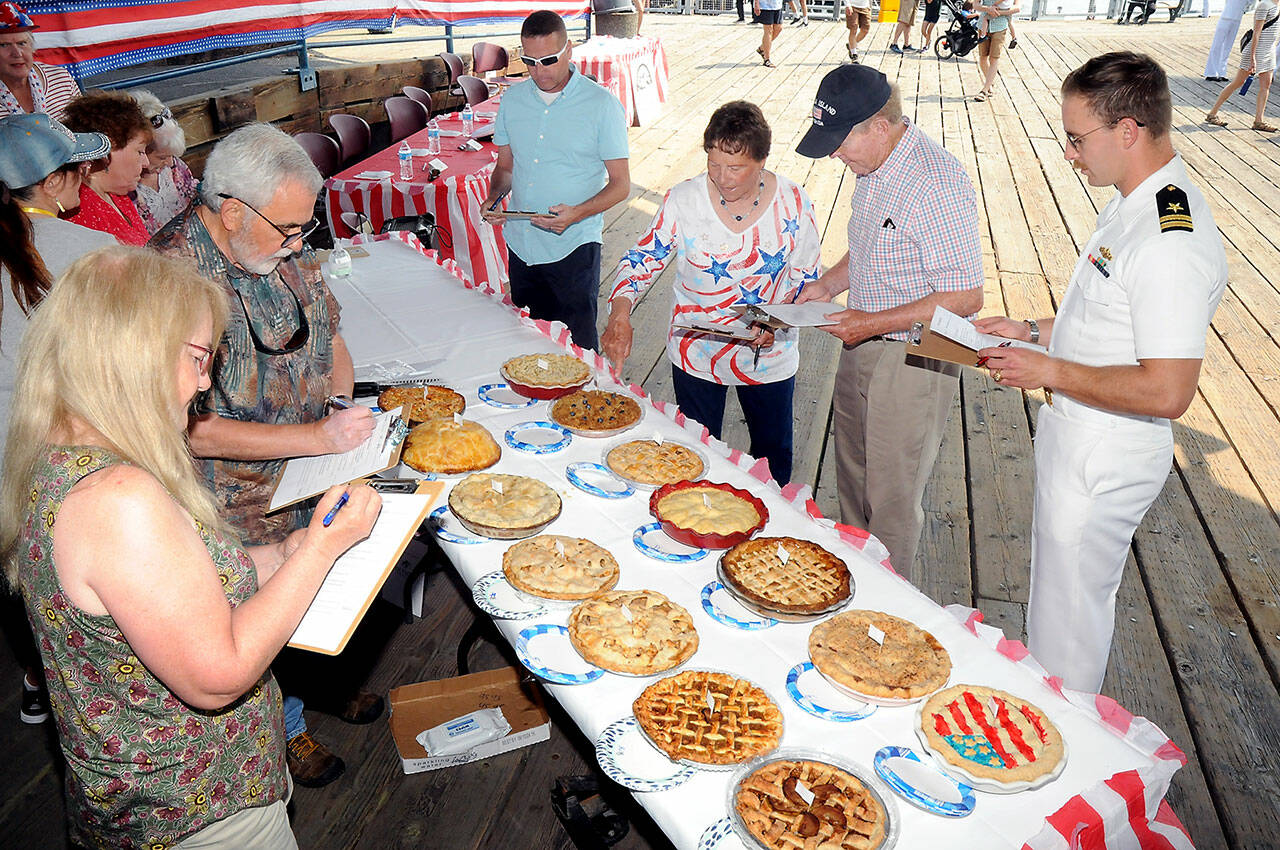 Apple pie contest judges, clockwise from left, Janet Lucas, John Brewer, Corey Delikat, Carol Johnson, Randy Johnson and Lt. Andrew Bergman judge entries prior to tasting during Independence Day festivities at Port Angeles City Pier. (Keith Thorpe/Peninsula Daily News)