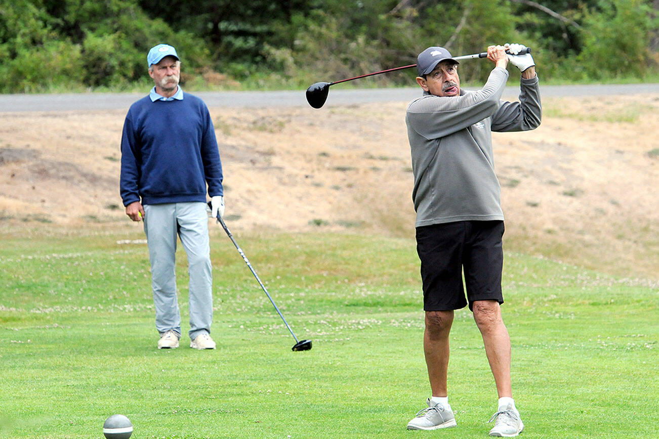 KEITH THORPE/PENINSULA DAILY NEWS
Gary Valencia of Port Angeles, right, tees off at the start of the Clallam County Amateur tournament on Friday at Peninsula Golf Course as Scott Hendricks, also of Port Angeles, awaits his turn.
