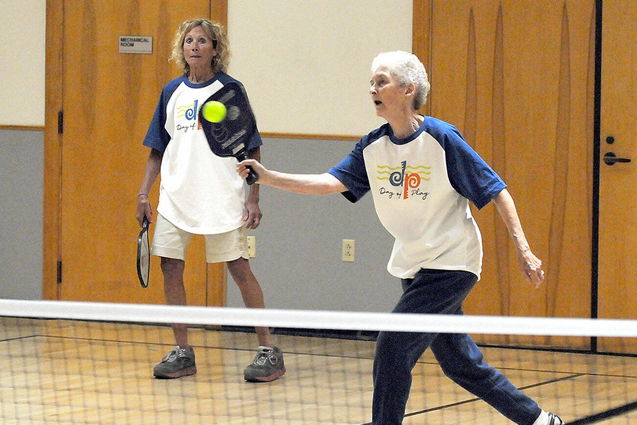 Nita Davidson, 85, of Port Angeles, front, and her teammate, Elyse Grosz, 72, of Port Angeles take on a game of pickleball on Saturday at the Port Angeles Senior Center, one of numerous venues for Day of Play, a celebration of recreational opportunities around the city. The event was arranged by the Port Angeles Parks and Recreation Department. (Keith Thorpe/Peninsula Daily News)