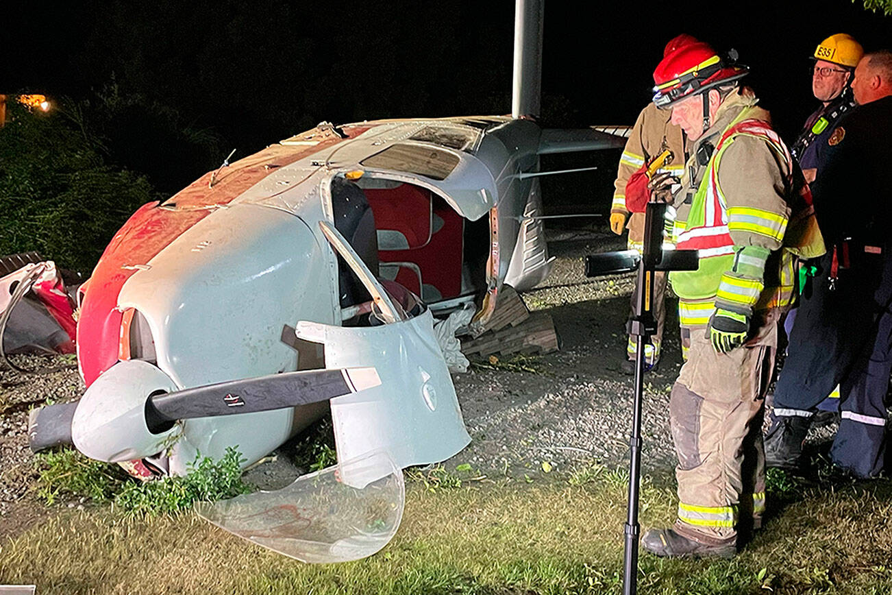 Firefighters with Clallam County Fire District 3 investigate a plane crash in Agnew on Saturday. Its passengers were transported with minor injuries to Olympic Medical Center in Port Angeles. (Matthew Nash/Olympic Peninsula News Group)