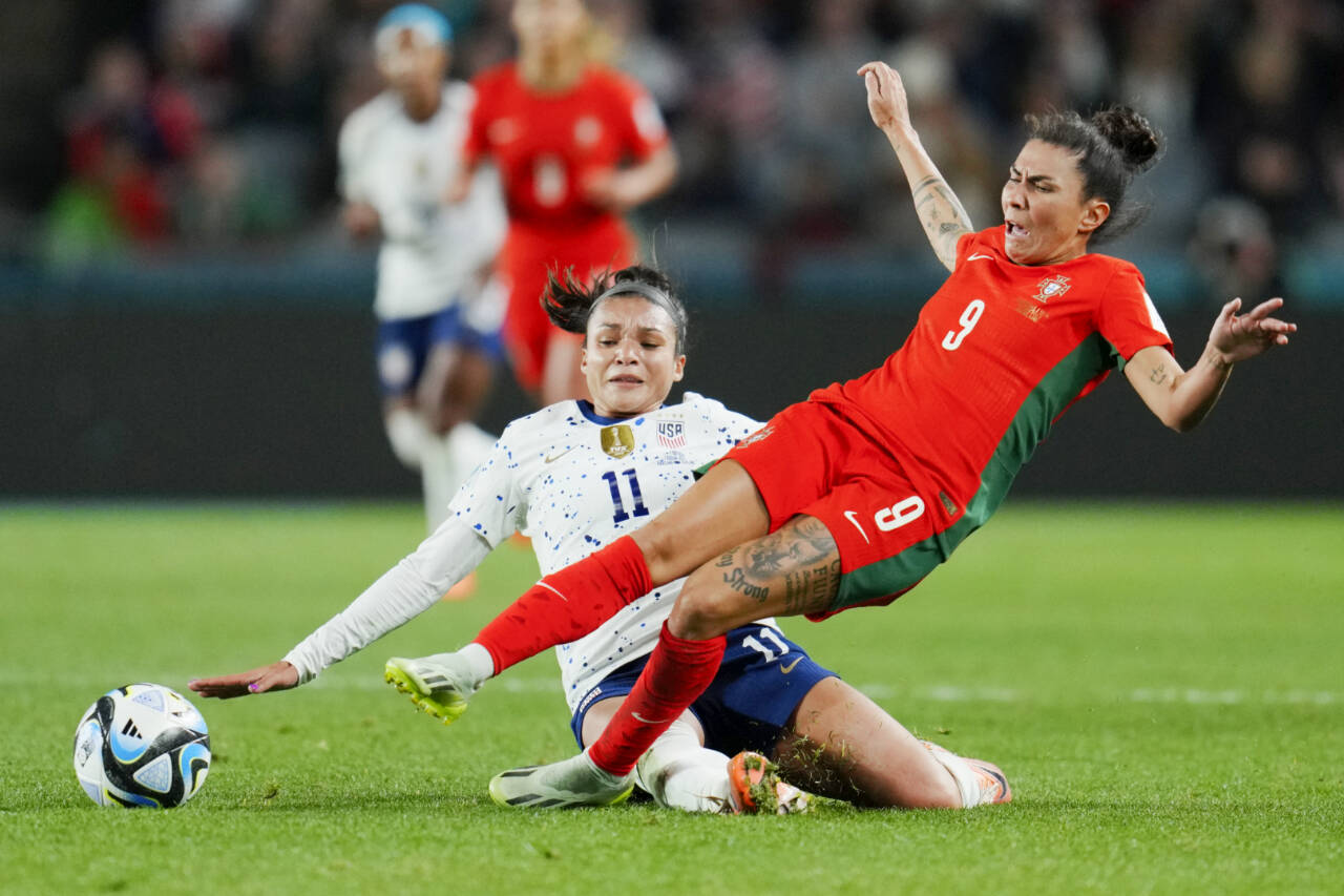 Portugal's Ana Borges, right, reacts as she is tackled by United States' Sophia Smith during the Women's World Cup Group E soccer match between Portugal and the United States at Eden Park in Auckland, New Zealand, Tuesday, Aug. 1, 2023. (AP Photo/Abbie Parr)