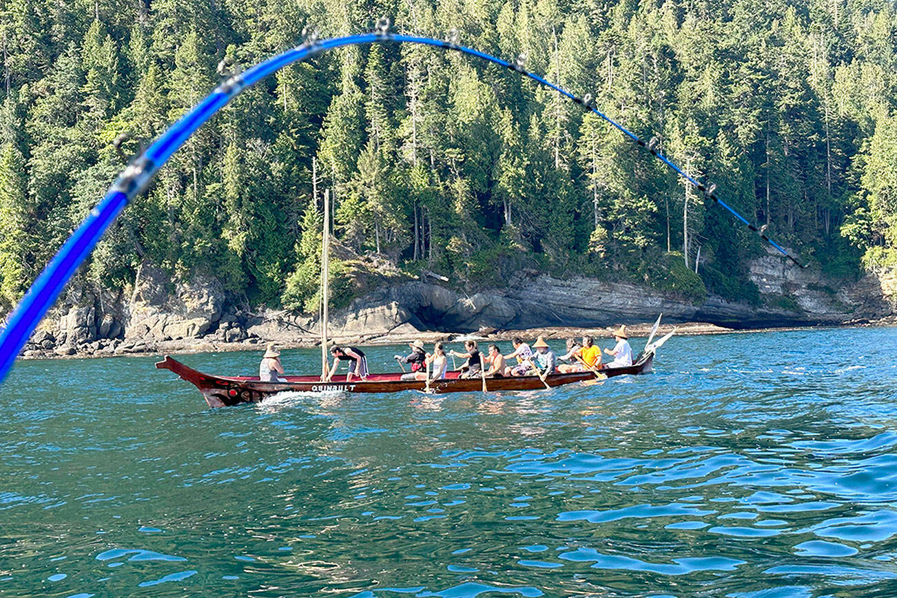 John L. Beath
The Quinault Nation canoe cuts through Freshwater Bay on the way to the mouth of the Elwha River and passes the downrigger line of Sequim angler John L. Beath during a July 23 fishing outing.