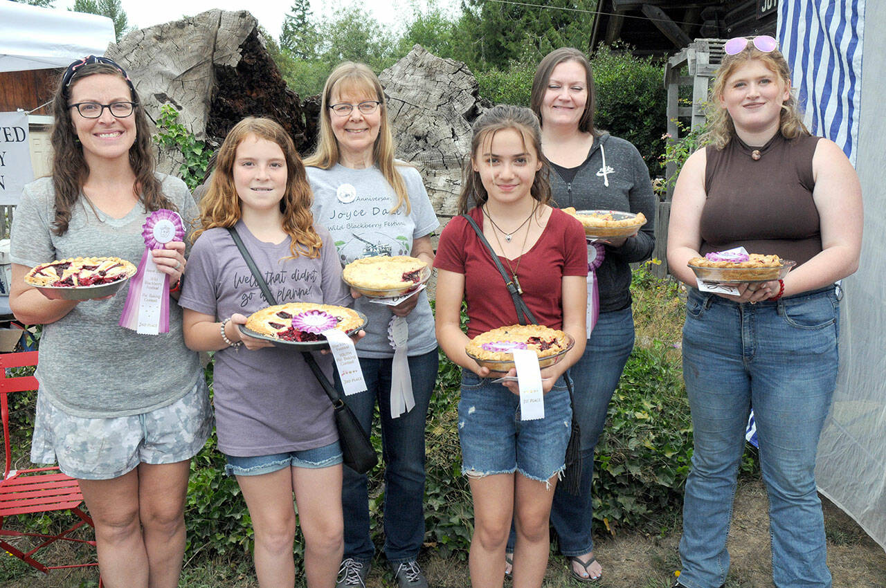 Blackberry pie contest winners, from left, Rachel Rice of Joyce (second place, adult), Audry Rice, 11, of Joyce (third place, youth), Janice Harsh of Port Angeles (third place, adult), Haylie Tenneson, 11, of Port Angeles (first place, youth), Tamara Stephens, Clackamas, Ore. (first place, adult) and Ariana Varholla, 15, of Sequim (second place, youth) display their pies and ribbons at the end of judging on Saturday. (Keith Thorpe/Peninsula Daily News)