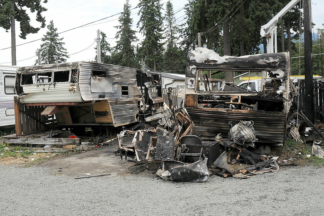 The charred remains of a pair of mobile homes sit on Saturday at the Emerald Mobile Home & RV Park in Port Angeles. (Keith Thorpe/Peninsula Daily News)