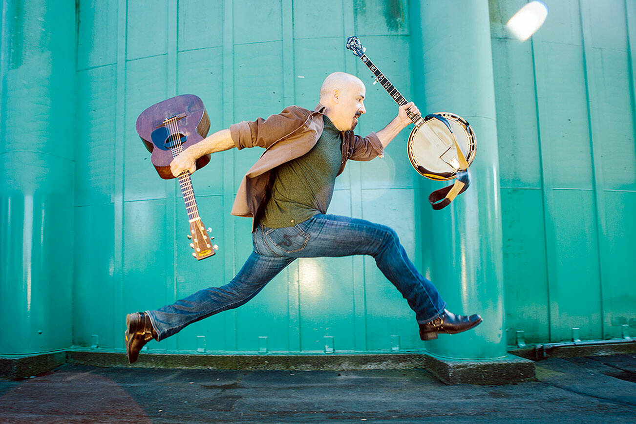 Tony Furtado clowns around with instruments.