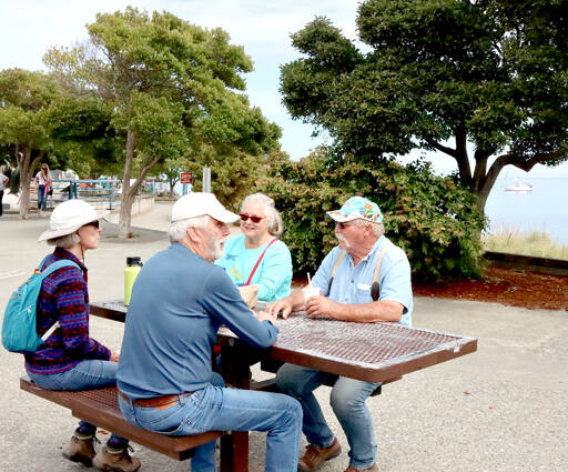 Carol and Greg Shinsky of Port Angeles take an afternoon break on a picnic table at the Port Angeles City Pier with visiting friends. Gay and Russ James, right, are visiting from Orland, Calif., where the temperature has been over 100 degrees. They rested at the pier after visiting Hurricane Ridge and the Dungeness Spit. The couples have known each other for years from when they both lived in Arizona. (Dave Logan/for Peninsula Daily News)