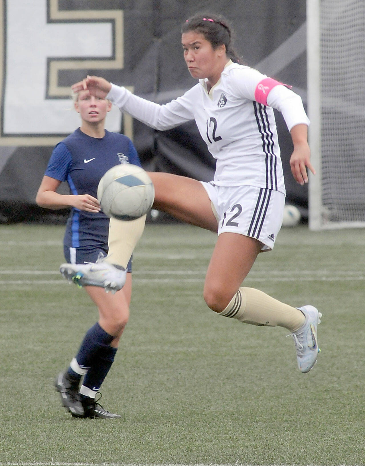 KEITH THORPE/PENINSULA DAILY NEWS Peninsula’s Keilee Silva steps high for the ball as Bellevue’s Daisy Morris look on during Wednesday’s match in Port Angeles.