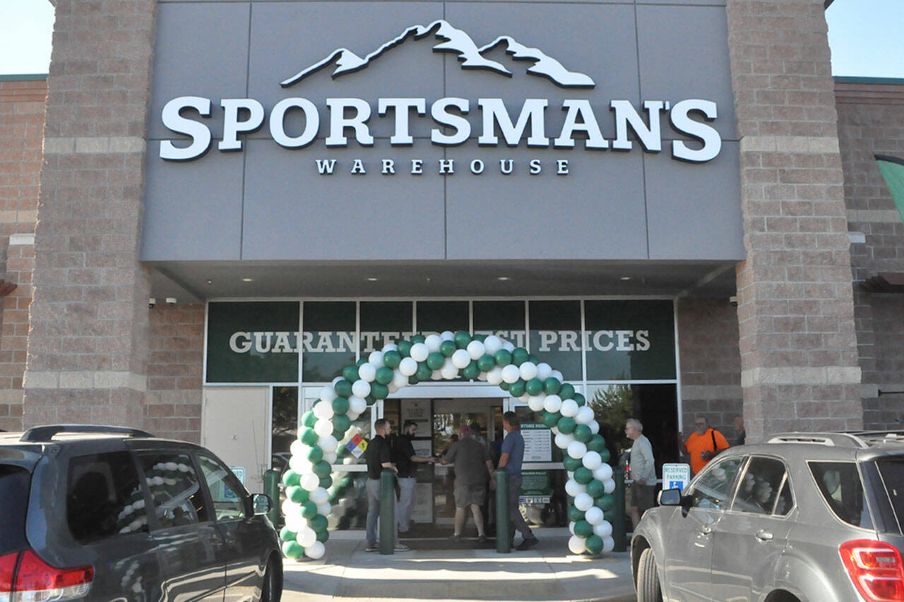 The first customers at Sequims Sportsmans Warehouse go inside during its grand opening. (Matthew Nash/ Olympic Peninsula News Group)