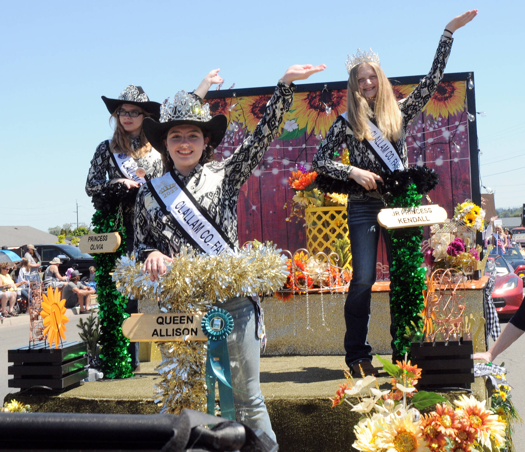Clallam County Fair royalty, from left, Princess Olivia Ostlund, Queen Allison Pettit and Junior Princess Kendall Adolphe ride their festival float, which received the Irrigation Festival Chairman’s Award at the Sequim Irrigation Festival in May.