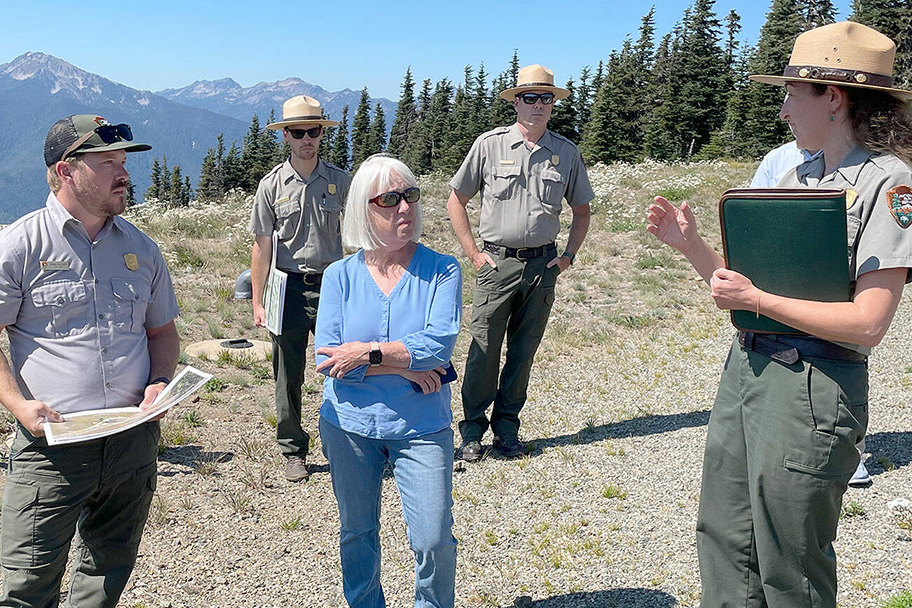 Sen. Patty Murray, center, listens to Olympic National Park Superintendent Sula Jacobs, right, explain the ongoing investigation into the cause of the fire that destroyed the Hurricane Ridge Day Lodge on May 7 and the park’s efforts to maintain visitor access this summer and possibly into the winter. (Paula Hunt/Peninsula Daily News)