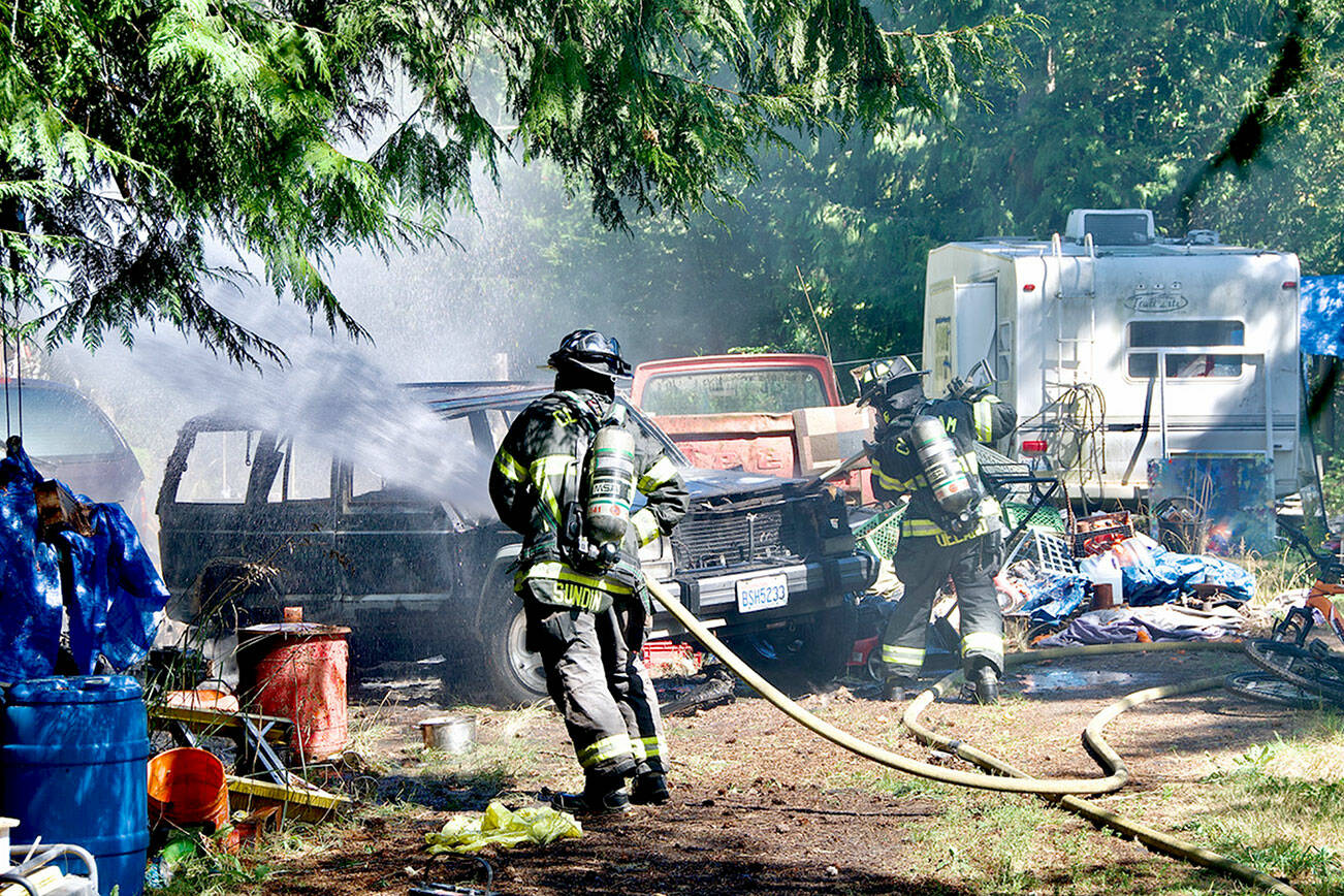 Clallam 2 Fire-Rescue firefighters battle a car fire on Lower Elwha Road.