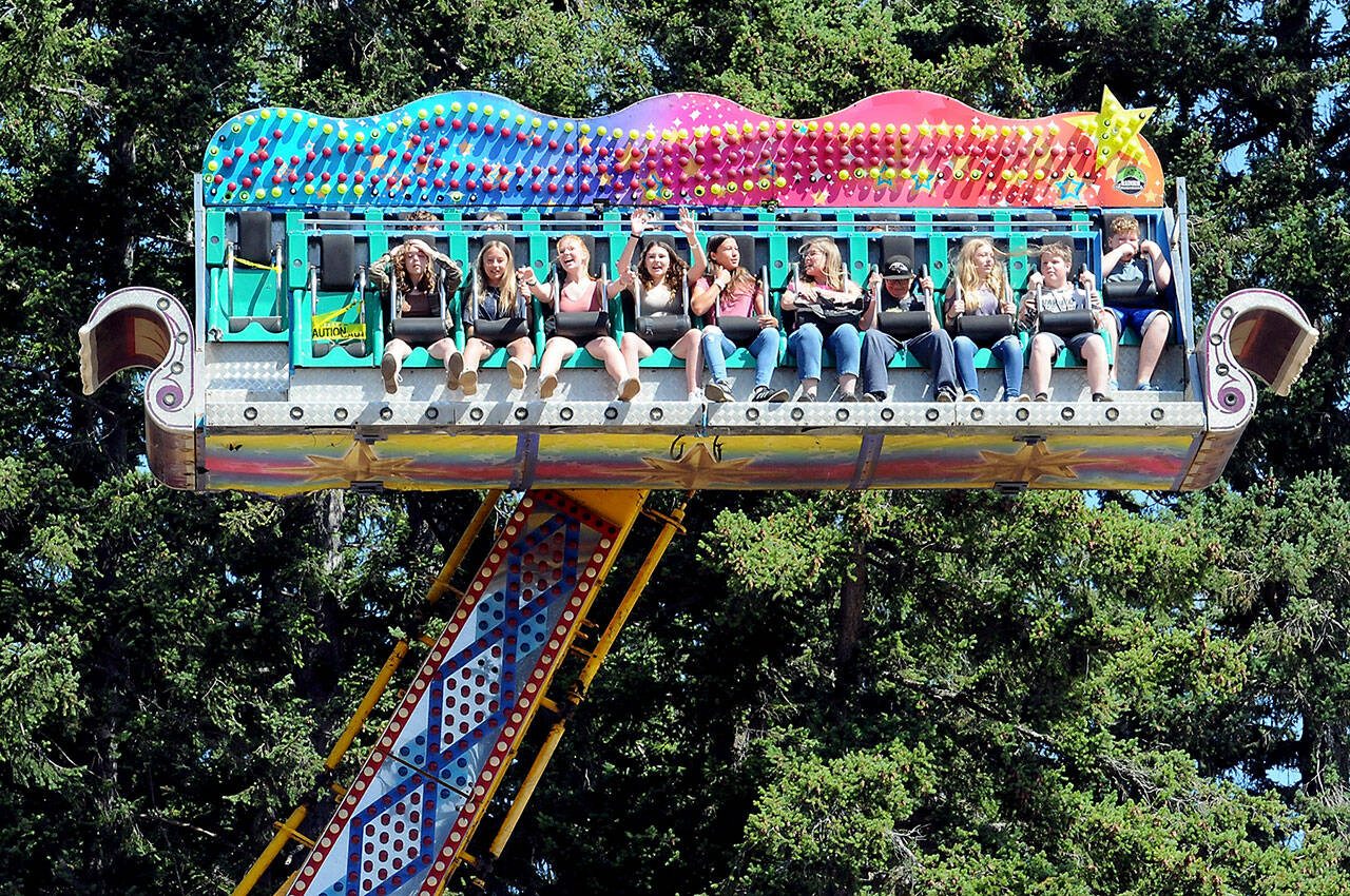 Carnival-goers take a spin through the air on the Ali Baba amusement ride at the Clallam County Fair in Port Angeles on Friday. (KEITH THORPE/PENINSULA DAILY NEWS)
