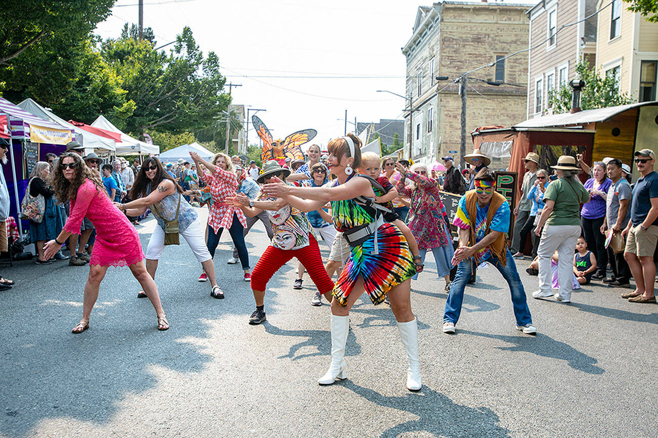 Zumba dancers perform on Lawrence Street during the Uptown Street Fair parade in Uptown Port Townsend on Saturday. Seventeen marching units, including this one, paraded down Lawrence Street in front of hundreds of spectators lining the sidewalk. (Steve Mullensky/for Peninsula Daily News)
