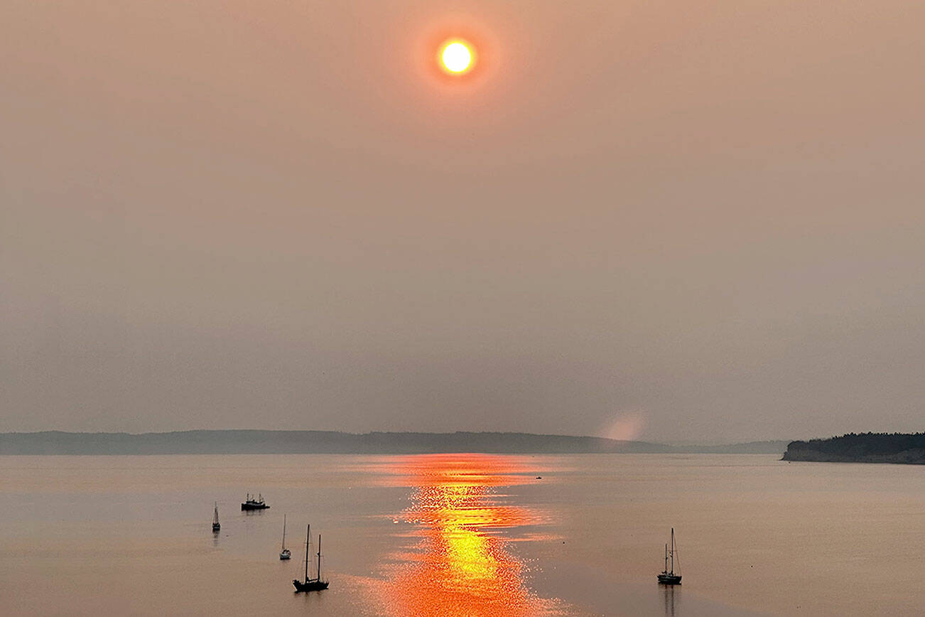 Smoke from wildfires in eastern Washington and Canada contribute to the red, smokey sunrise on Sunday over Port Townsend. (Steve Mullensky/for Peninsula Daily News)