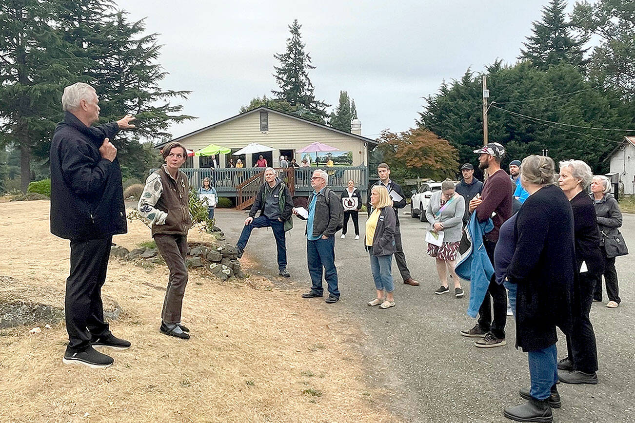 The Port Townsend City Council on Monday visited Mountain View Commons and the city golf course to get a first-hand look at the properties which are under consideration for alternative uses. Tim Caldwell, left, a member of the Port Townsend Golf Course stakeholder committee, describes the clubhouse and course layout. (Paula Hunt/Peninsula Daily News)
