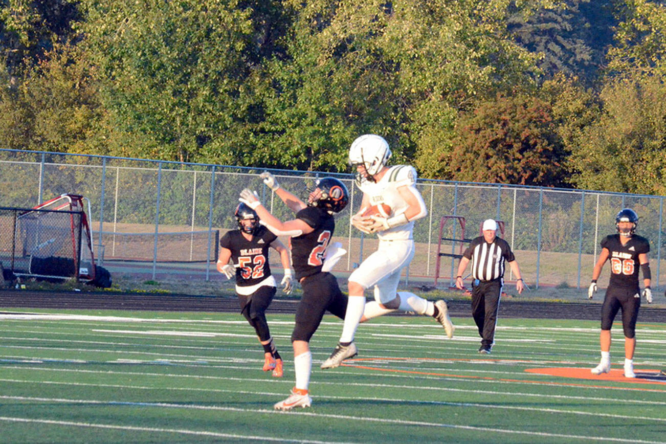 Port Angeles' Blake Sohlberg hauls in this 45-yard catch-and-run touchdown pass to give the Roughriders a 9-0 lead early in their 44-21 win over Blaine Friday night. Sohlberg also had three interceptions. (Jack Kintner photo)