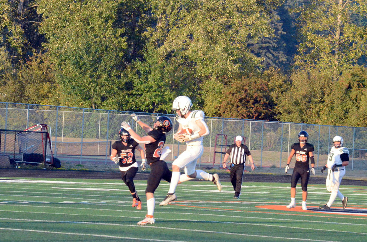 Port Angeles Blake Sohlberg hauls in this 45-yard catch-and-run touchdown pass to give the Roughriders a 9-0 lead early in their 44-21 win over Blaine Friday night. Sohlberg also had three interceptions. (Jack Kintner photo)