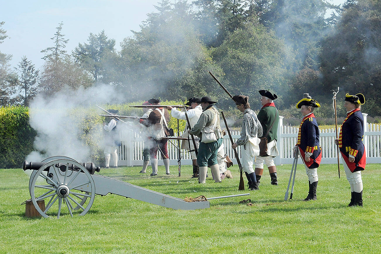A collection of American militiamen fire upon English Redcoats during a mock skirmish at the Northwest Colonial Festival near Agnew on Saturday. The event, hosted by the George Washington Inn, featured historical displays and interpretations of life during the Revolutionary War era. (Keith Thorpe/Peninsula Daily News)