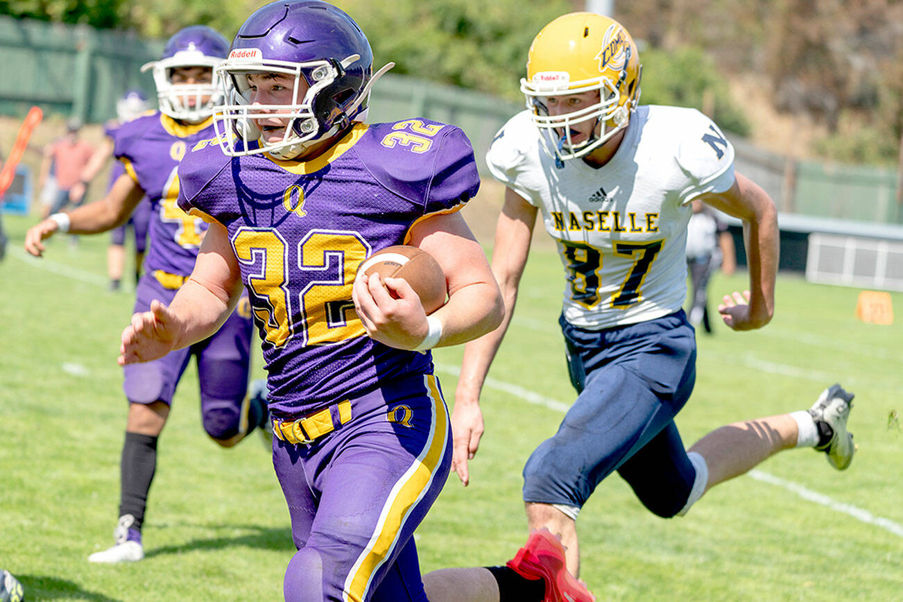 Quilcene’s Mason Iverson, 32, rushes around Naselle’s Jacob Pakanen and picks up a first down during a Saturday game played at Port Townsend’s Memorial Field. (Steve Mullensky/for Peninsula Daily News)