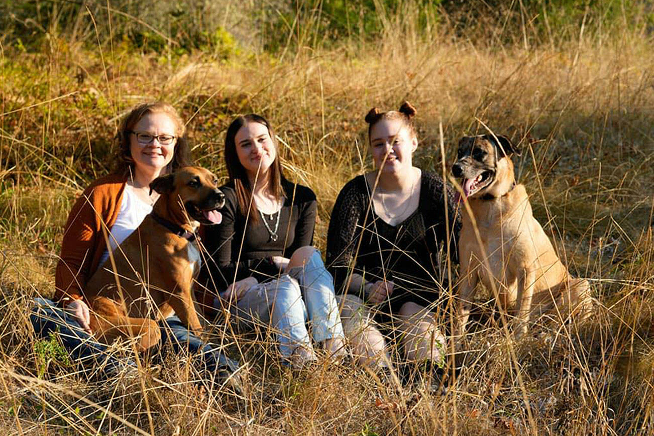 Rachael Healey, left, and her two daughters, Kaitlyn, 18, middle, and Kenzie, 16, right, lost their Dungeness home and two dogs Stella, front left, and Ollie, in a fire on Aug. 23. The family seeks a new place to rent as they live in a hotel while continuing to work and go to school. (Rachael Healey)