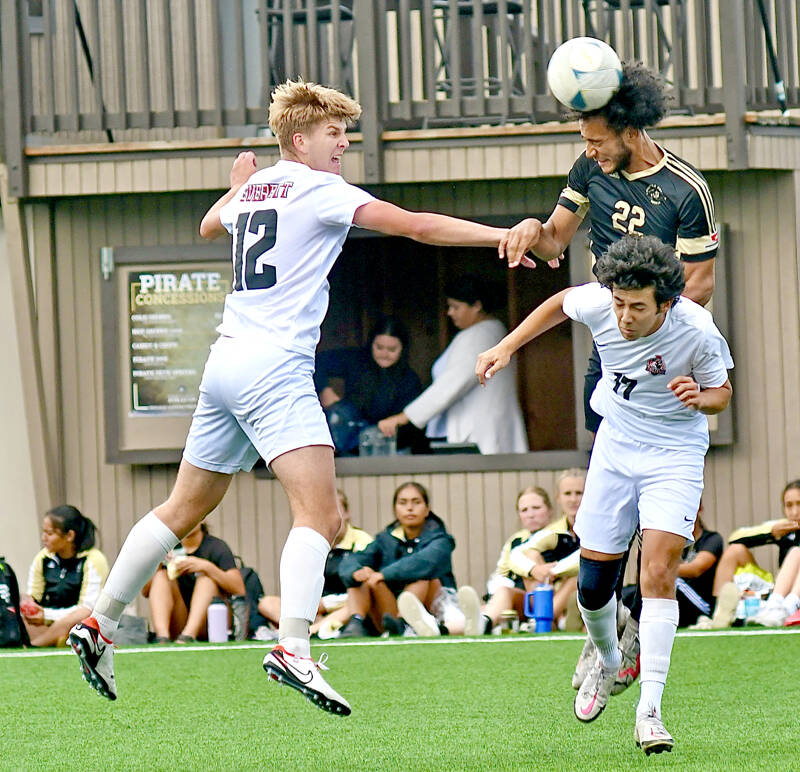 Peninsula College’s Jem Ndja (22) heads the ball upfield while defended by Everett’s Reid Schaeffer, left, and Luis Carillo during the Pirates’ 3-2 home loss Wednesday at Wally Sigmar Field. (Jay Cline/Peninsula College Athletics)