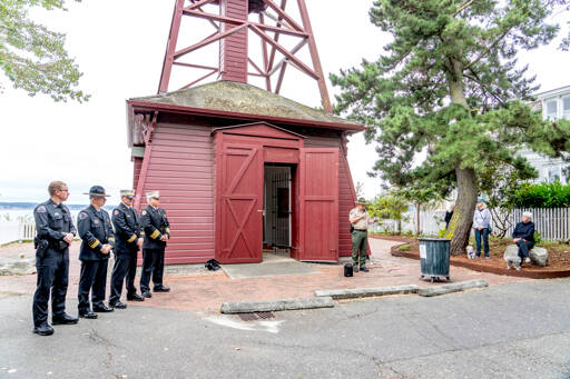 Port Townsend Police Officer Jon Stuart, Chief Thomas Olson, Assistant Fire Chief Brian Tracer and Fire Chief Bret Black observe a moment of silence Monday as Jefferson County Sheriff Joe Nole reads a remembrance of the terrorist attacks on the World Trade Center in New York on Sept. 11, 2001. (Steve Mullensky/for Peninsula Daily News)