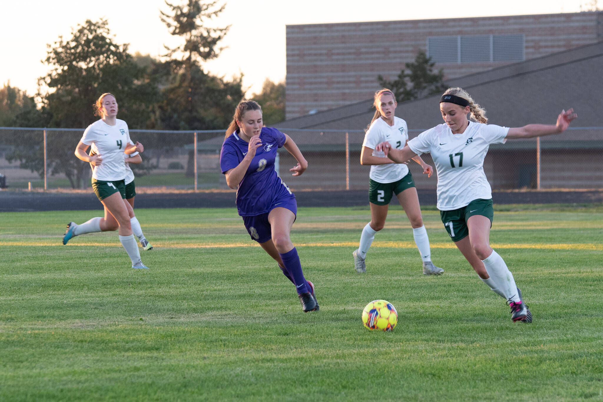 Port Angeles’ Ava-Anne Sheahan dribbles upfield while Sequim’s Nikoline Updike gives chase during the Wolves’ 2-1 Rainshadow Rumble rivalry win Thursday in Sequim.
