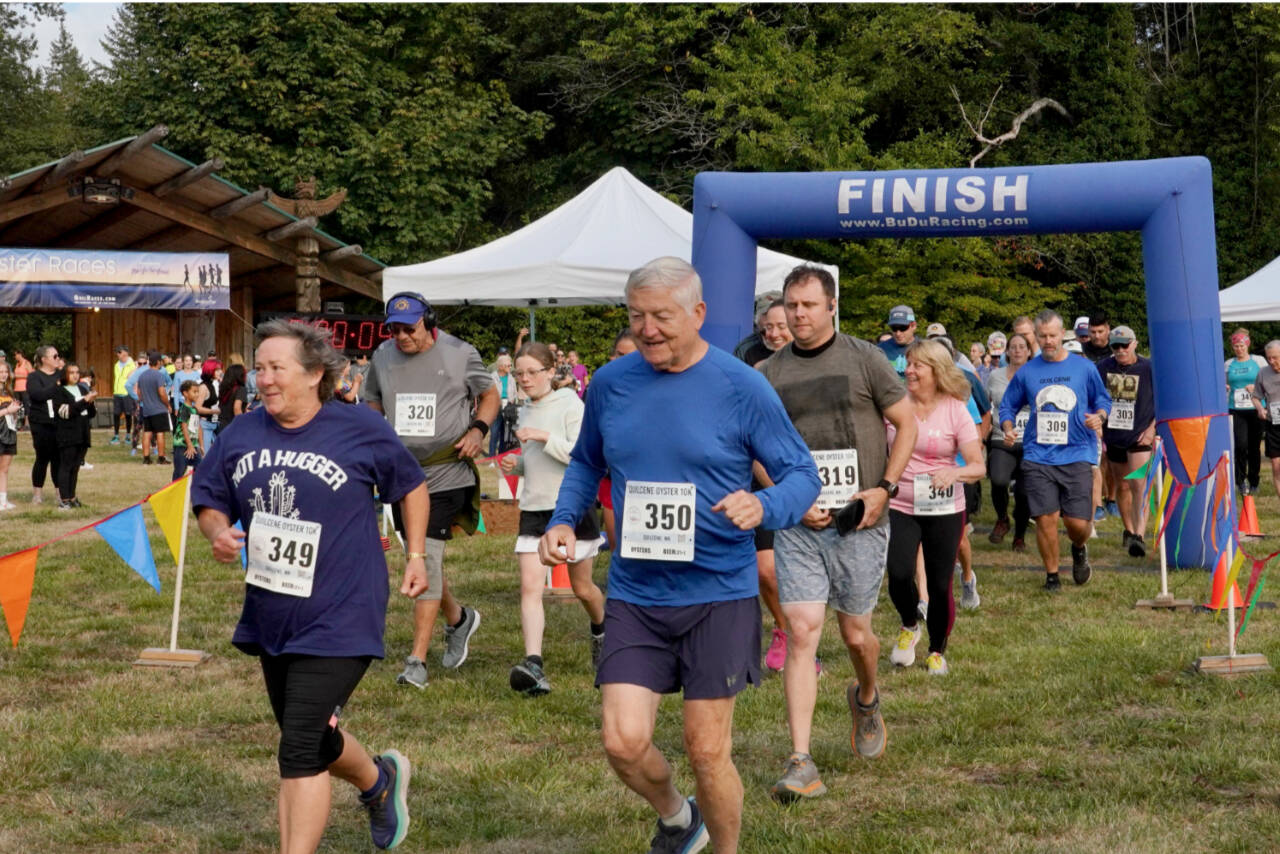 Amy Warrick of Port Ludlow (349) and James Kelly of Port Ludlow (350) lead the way during the start of the Quilcene Oyster Run 10K on Sunday. (Jeff Childs photo)