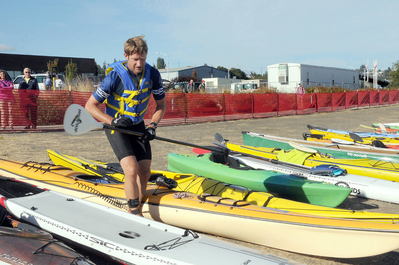 Ian Mackie of Gig Harbor prepares to launch his kayak from Pebble Beach as an iron man competitor during the 2022 Big Hurt in Port Angeles. (Keith Thorpe/Peninsula Daily News)
