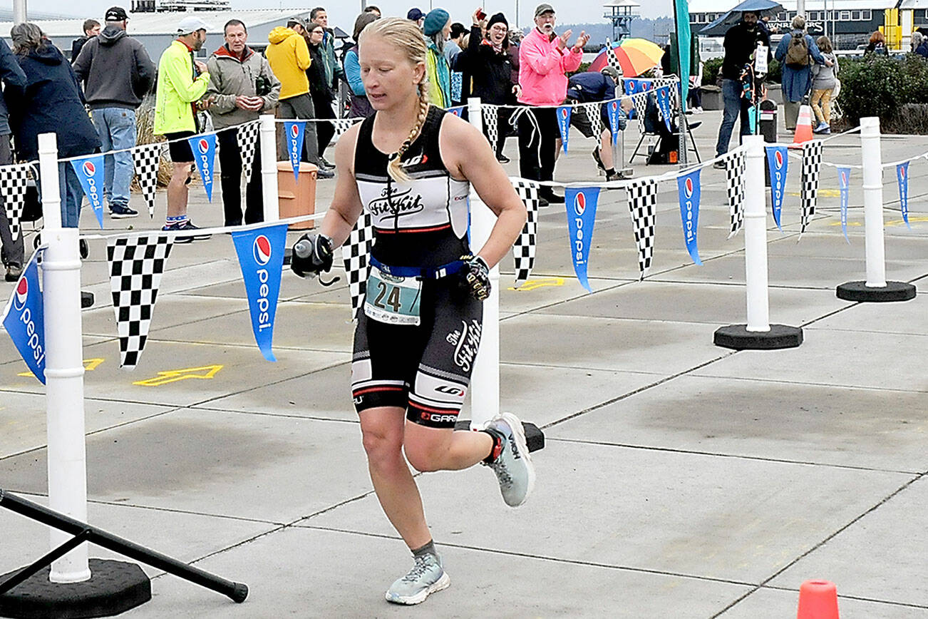 KEITH THORPE/PENINSULA DAILY NEWS
Jennifer Higgins of Bozeman, Mont., crosses the line as top womans racer in the ironman category of Saturday's Big Hurt in Port Angeles.