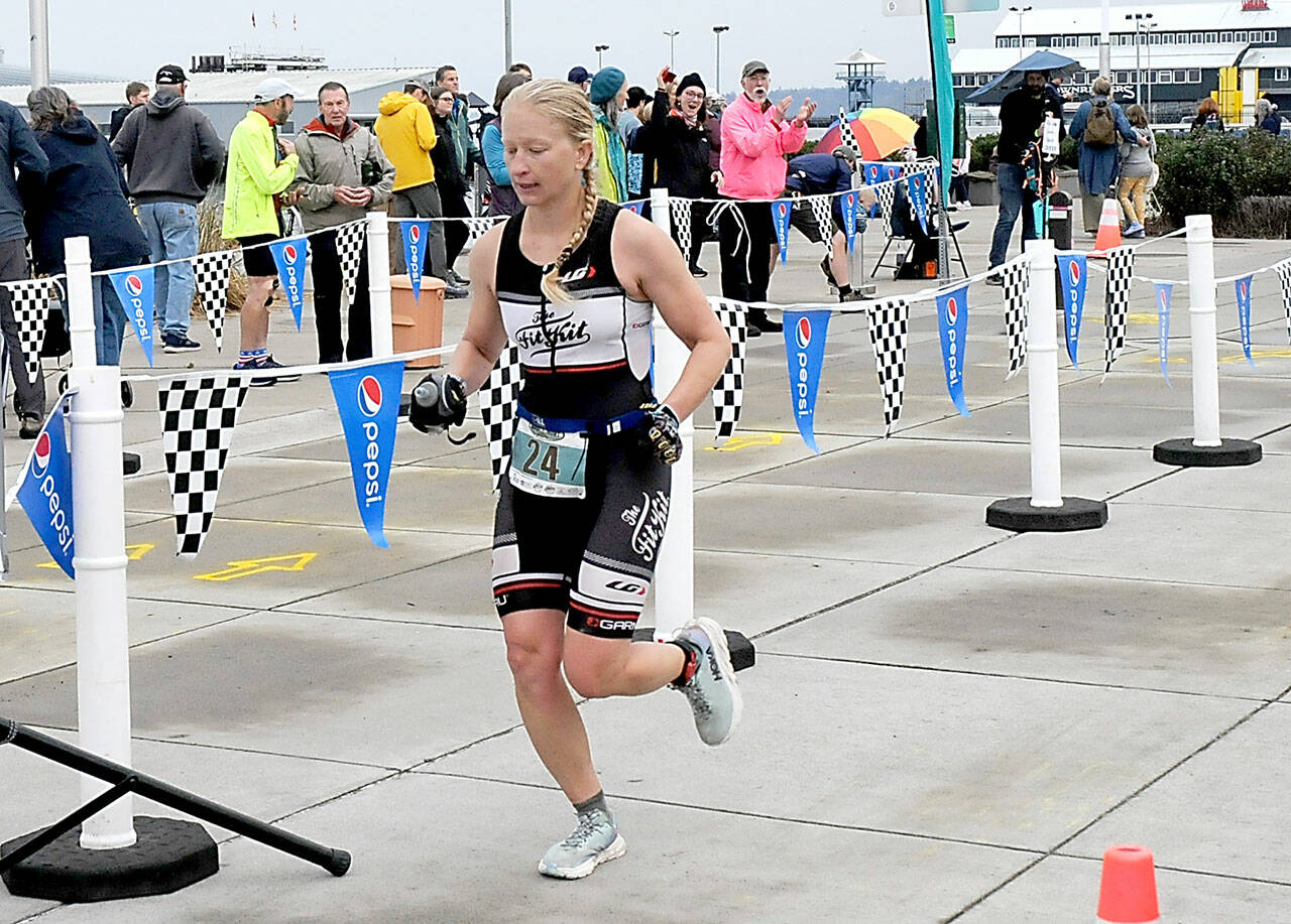 KEITH THORPE/PENINSULA DAILY NEWS Jennifer Higgins of Bozeman, Mont., crosses the line as top womans racer in the ironman category of Saturday’s Big Hurt in Port Angeles.