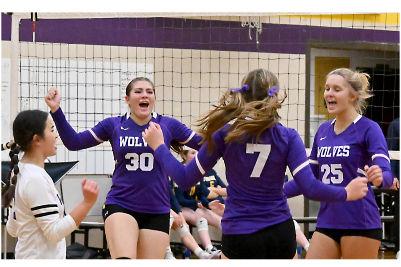 From left, Tiffany Lam, Brianna Palenik, Sydney Clark and Jolene Vaara celebrate winning a point against Bainbridge on Tuesday night. (Michael Dashiell/Olympic Peninsula News Group)