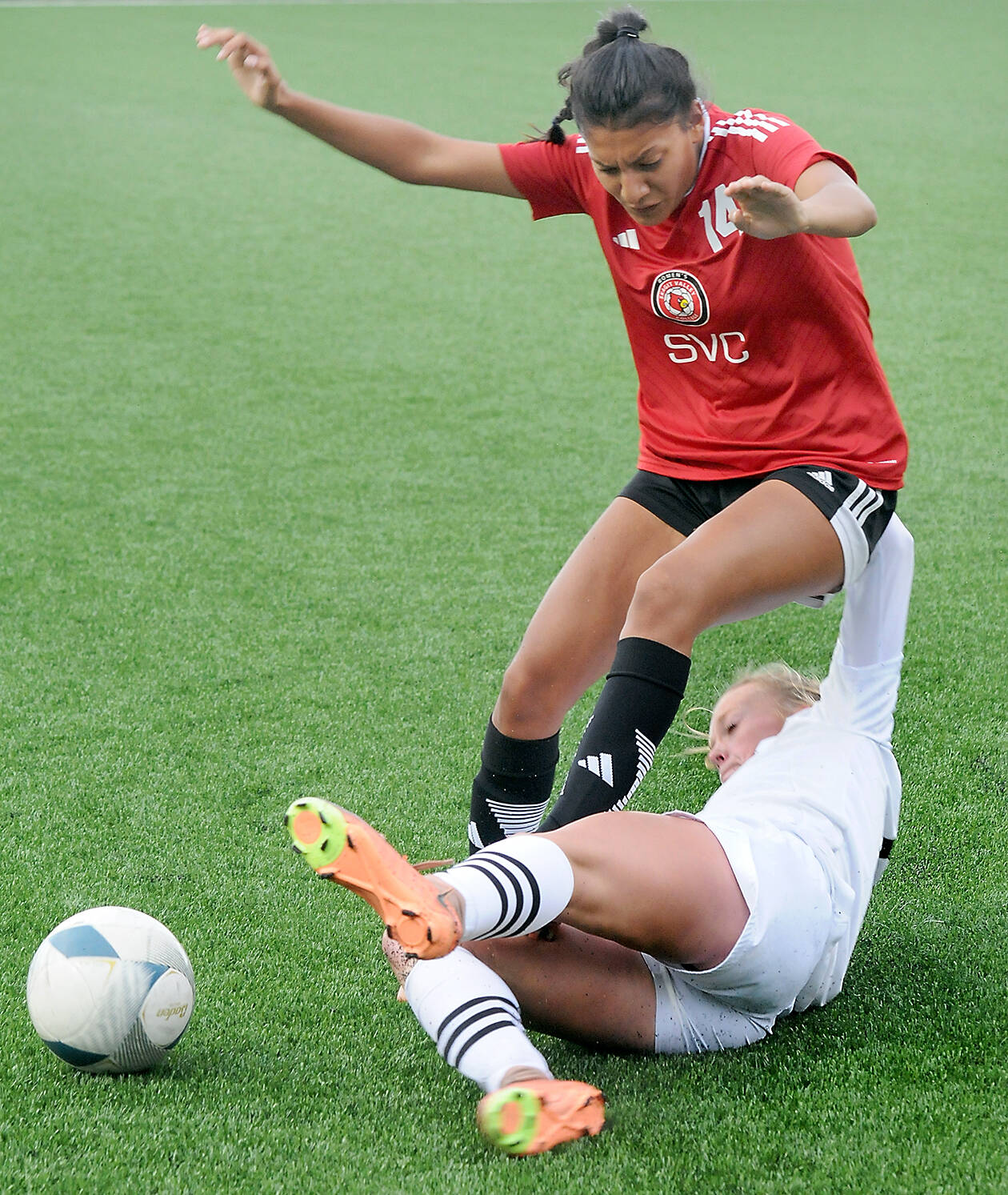 KEITH THORPE/PENINSULA DAILY NEWS 
Peninsula’s Anna Petty, bottom, makes a sliding tackle on Skagit Valley’s Liz Cisneros during Wednesday’s match at Peninsula College.