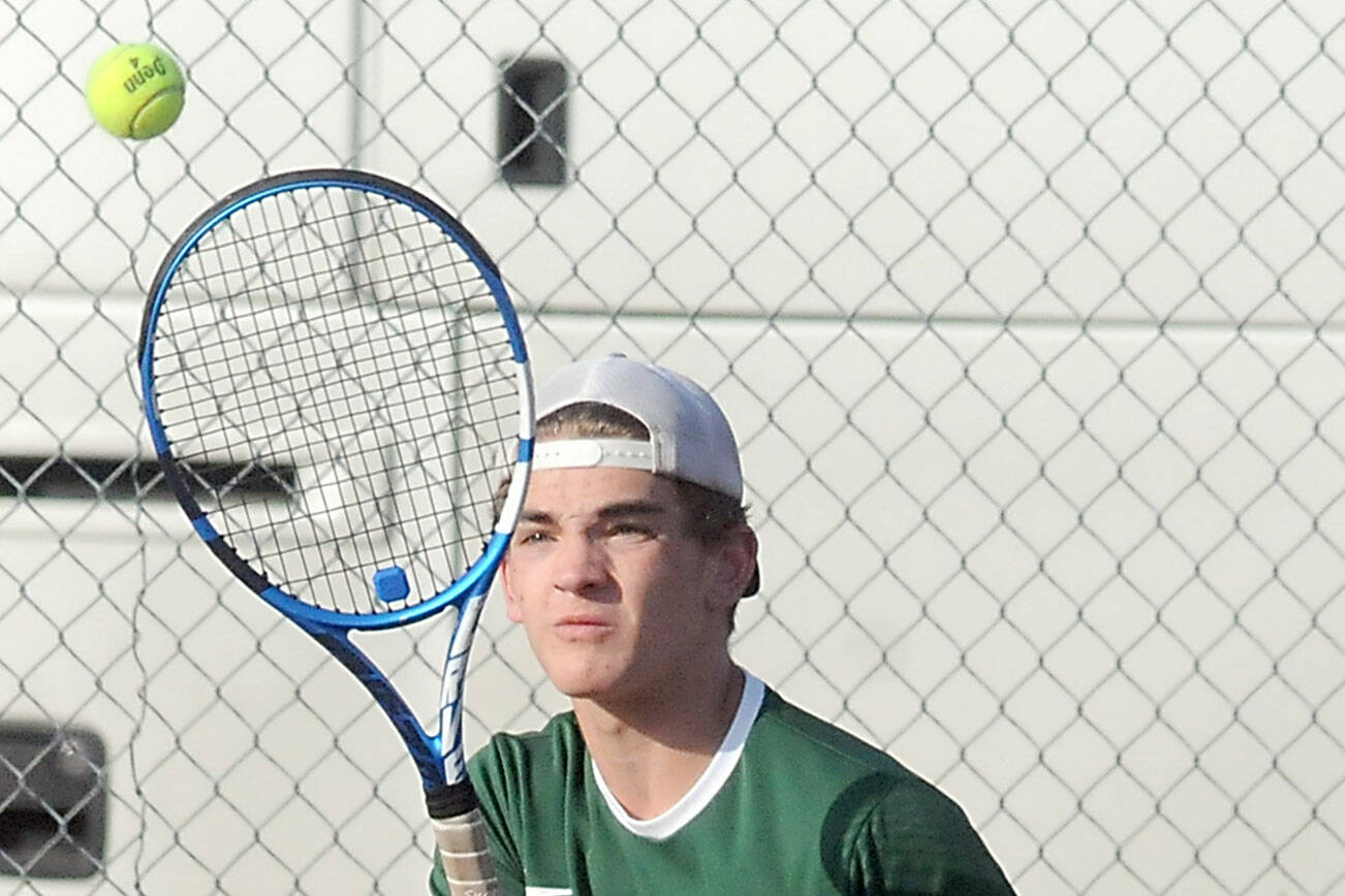 KEITH THORPE/PENINSULA DAILY NEWS
Port Angeles' Nathan Basden gets the return in his singles match against Olympic's Jonah Pantig on Thursday at Port Angeles High School.