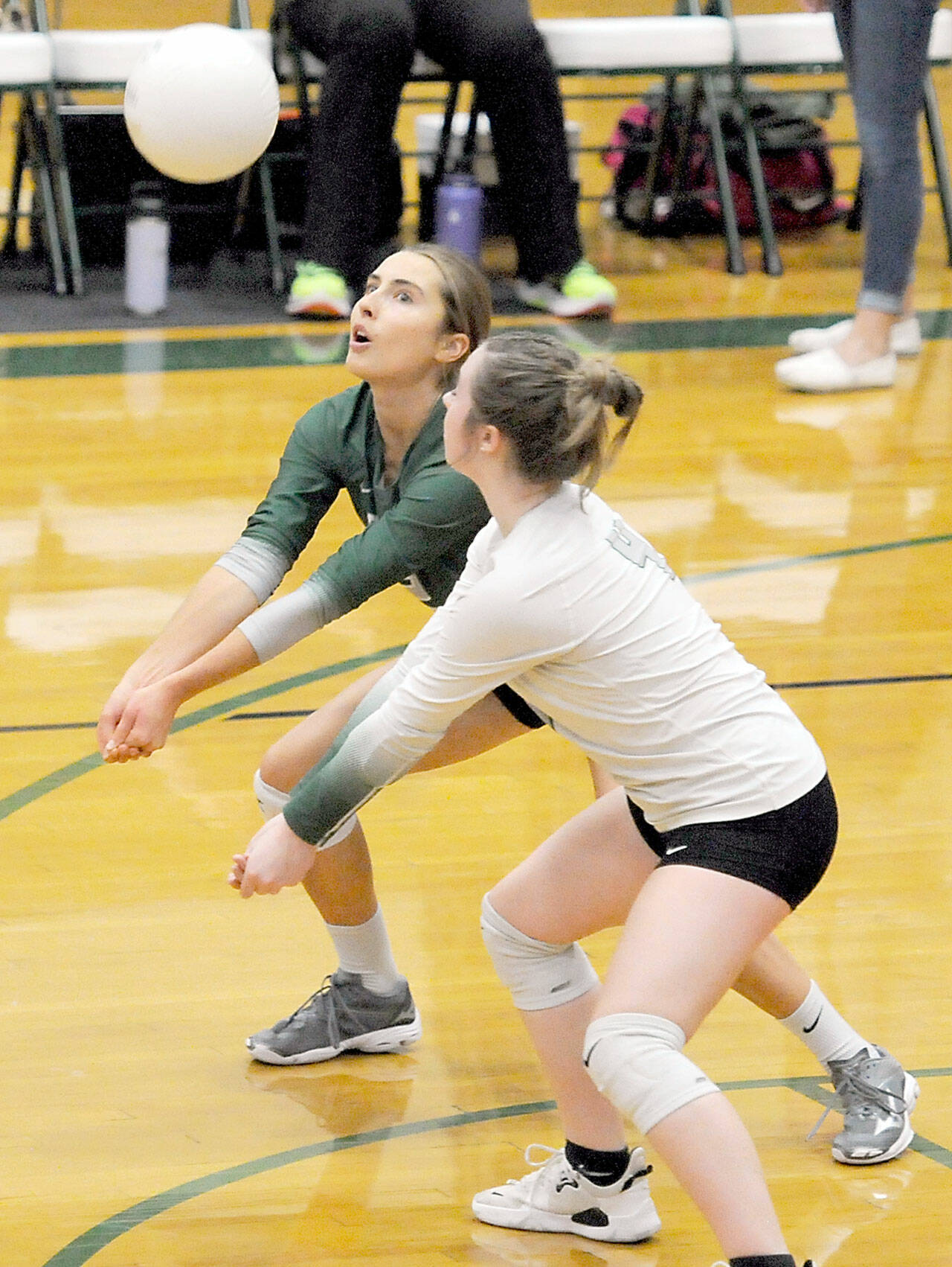 KEITH THORPE/PENINSULA DAILY NEWS Port Angeles’ Mary Halberg, left, and lebero Lily Thomas back each other up on receiving the serve during their match against Bainbridge on Thursday at Port Angeles High School.