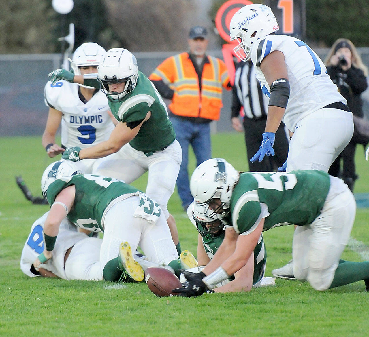 KEITH THORPE/PENINSULA DAILY NEWS Port Angeles’ Tanner Flores, lower right, dives for a fumble knocked loose from Olympic’s Ryan Macazo, lower left by Roughrider Ezra Townsend on Friday at Port Angeles Civic Field. Looking on were, from left, Olympic’s Antonio Castorena, Port Angeles’ Jason Hawes and Olympic’s DeQuan Freeland.