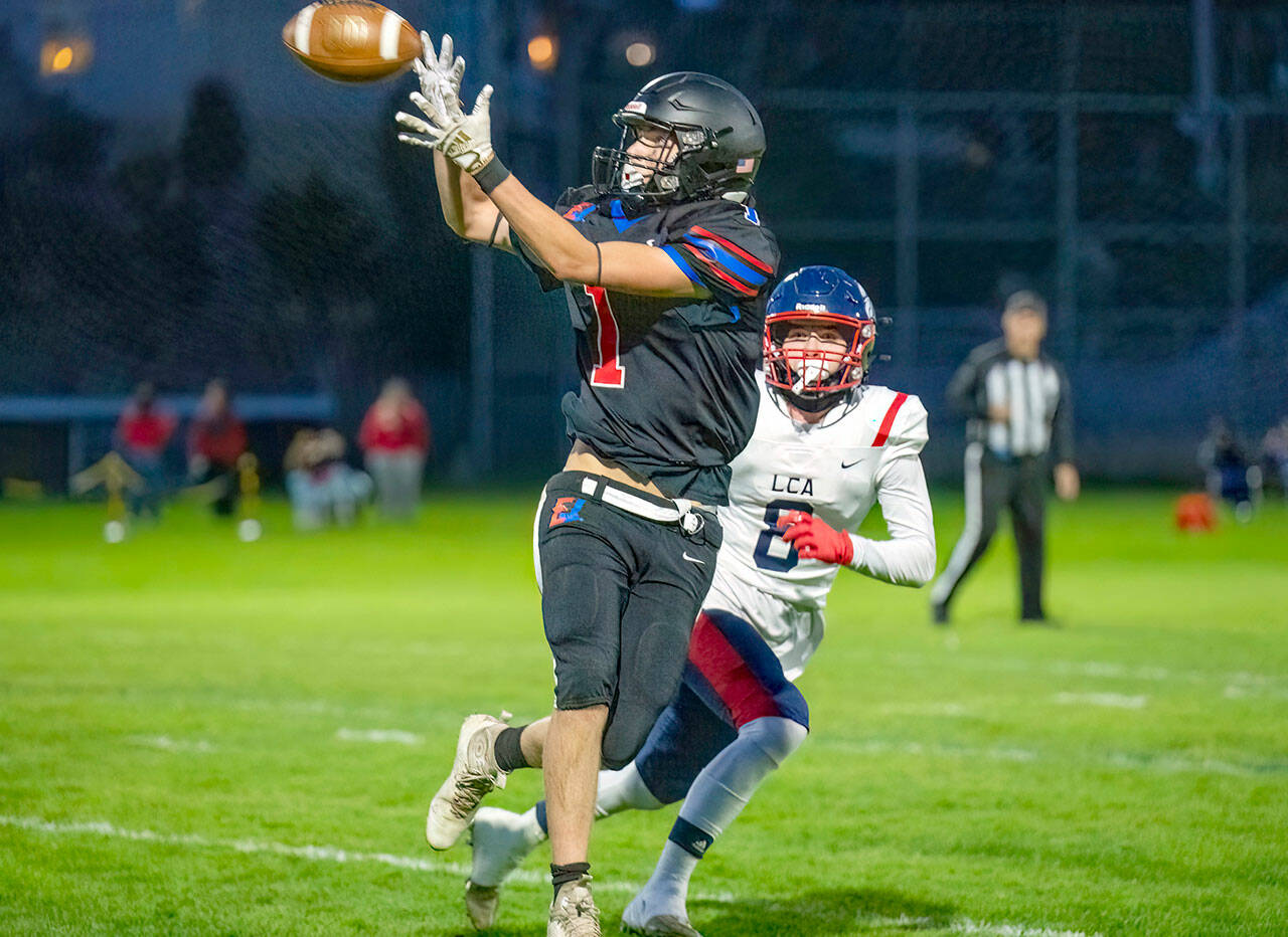 East Jefferson wide receiver Gary Zambor makes the catch for a 15-yard gain and a first down, with Life Christian’s Tyler Hamm looking on, in first quarter action Friday night at Port Townsend Memorial Field. Life Christian won 66-12. (Steve Mullensky/for Peninsula Daily News).