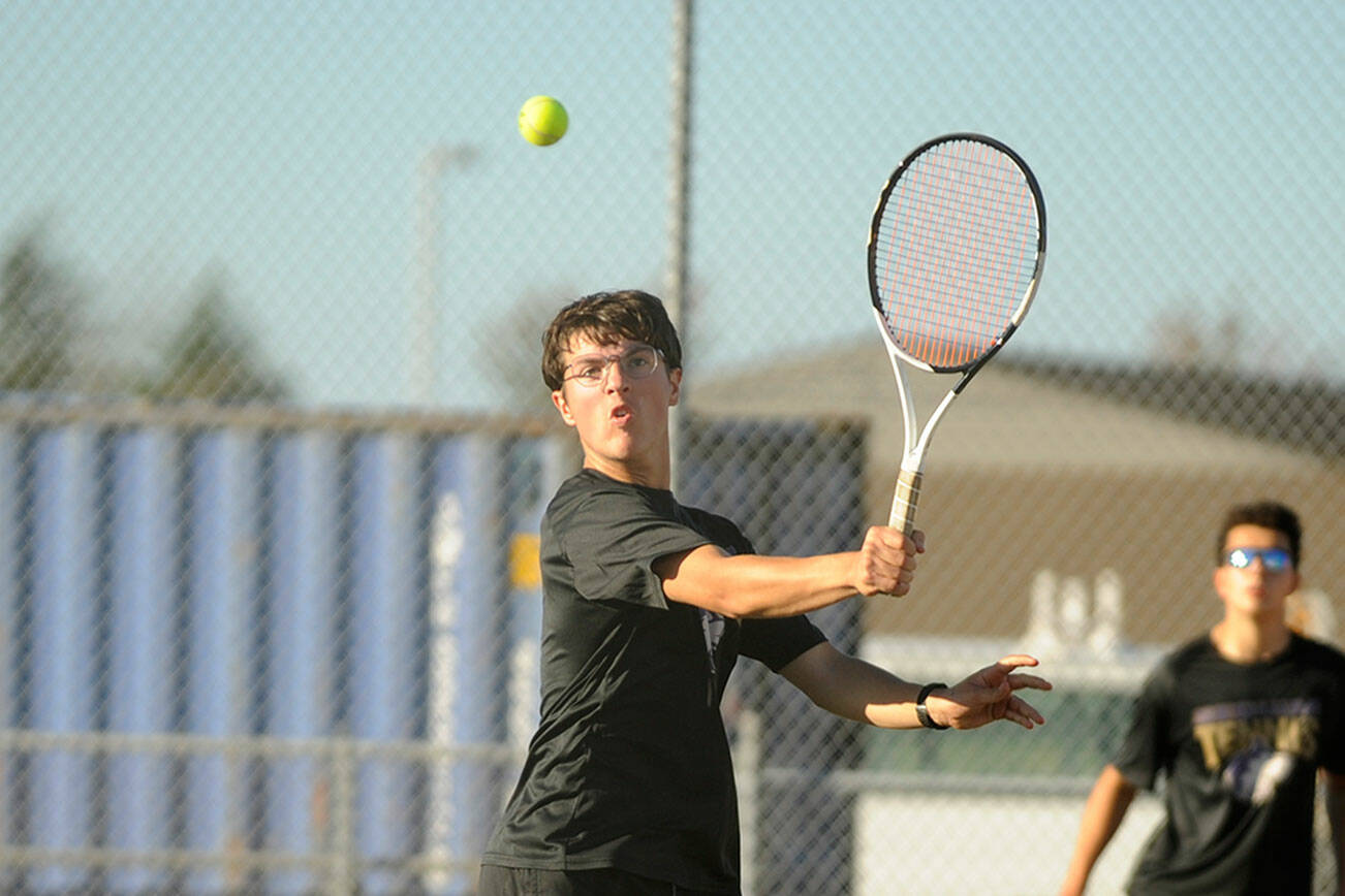 Michael Dashiell/Olympic Peninsula News Group
Sequim's William Hughes, front, returns a shot while doubles partner Tom Laschet looks on during the Wolves' match with Kingston on Thursday.