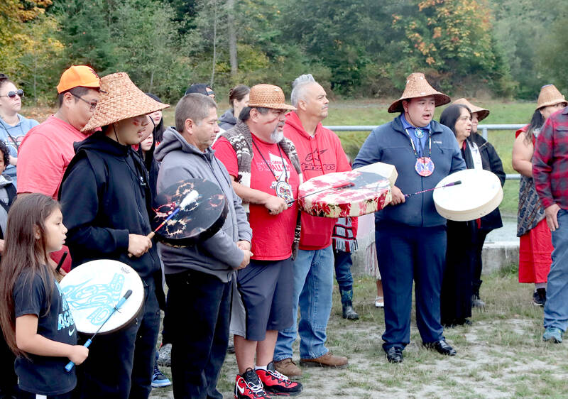 Lower Elwha Klallam tribal members sing the “Salmon Song” led by Jonathan Arakawa, right. More than 100 people attended the outdoor ceremony Monday near the banks of the Elwha River at the Lower Elwha Klallam Hatchery, 700 Stratton Road. The tribe has been waiting for the go-ahead to fish the Elwha like their ancestors did a century ago. The fishery will be a mix of hook-and-line and river nets, and fishing will continue until the quota of 400 has been met. (Dave Logan/for Peninsula Daily News)