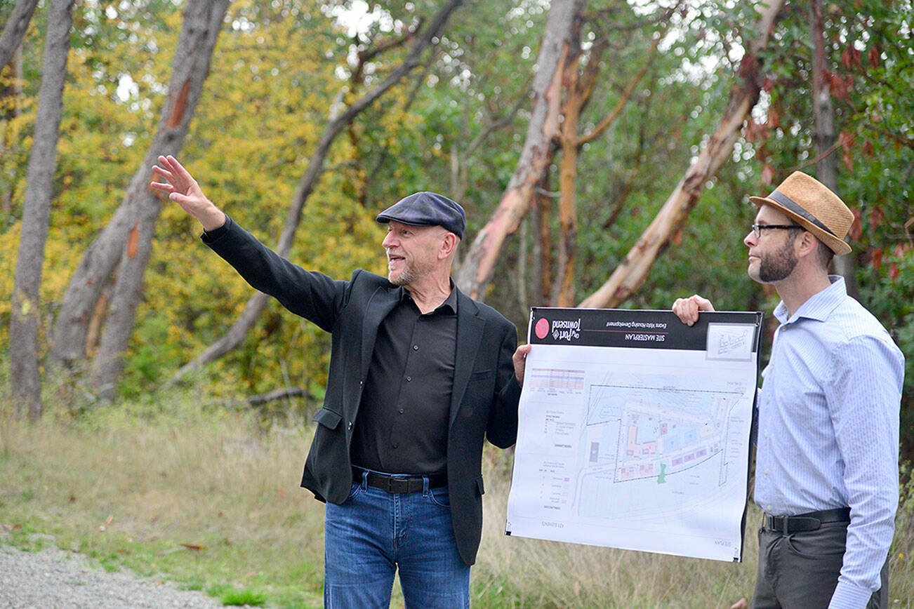 Thomas Architecture Studios Principal Ron Thomas, left, and Associate Principal Amos Callender hold up a map of the proposed Evans Vista development in Port Townsend on Monday during a tour of the site with members of the Port Townsend City Council and the public. The project is in its final planning stages and a final plan will be determined at a Nov. 6 council meeting. (Peter Segall/Peninsula Daily News)
