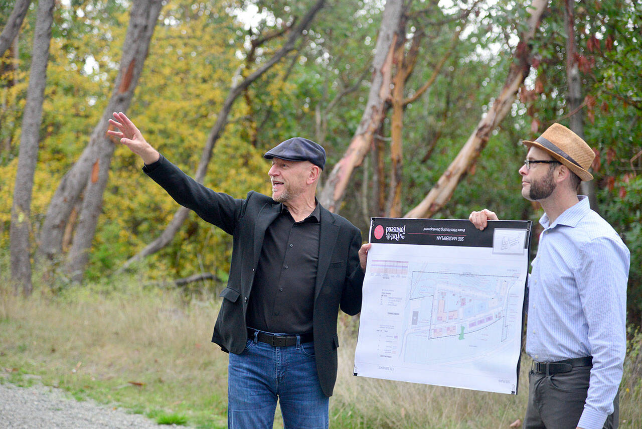 Thomas Architecture Studios Principal Ron Thomas, left, and Associate Principal Amos Callender hold up a map of the proposed Evans Vista development in Port Townsend on Monday during a tour of the site with members of the Port Townsend City Council and the public. The project is in its final planning stages and a final plan will be determined at a Nov. 6 council meeting. (Peter Segall/Peninsula Daily News)