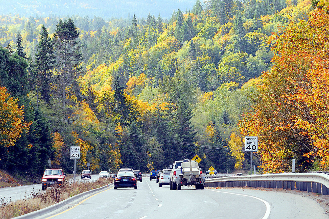 Traffic makes its way down U.S. Highway 101 at Morse Creek east of Port Angeles against a backdrop of colorful fall foliage. With autumn getting into full swing, trees are going into their fall colors before falling into the grayness of winter. (Keith Thorpe/Peninsula Daily News)