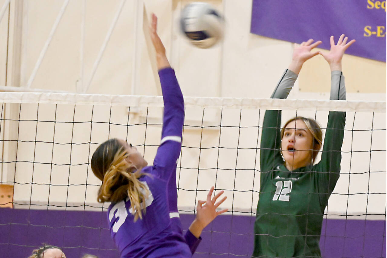 Sequim’s Arianna Stovall (33) looks to spike the ball as Port Angeles’ Natalie Tenneson (12) looks to block. Also looking on are Port Angeles’ Josephine Edgington (3) and Paige Pangaro (13). (Michael Dashiell/Olympic Peninsula News Group)