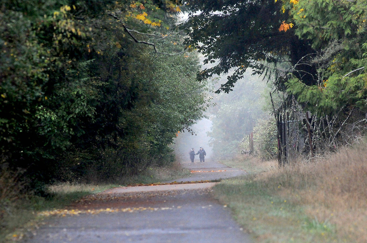 Walkers make their way along a foggy portion of the Olympic Discovery Trail near William R. Fairchild International Airport in Port Angeles. Areas of fog covered many portions of the North Olympic Peninsula on Thursday with wetter weather forecast for the weekend. (Keith Thorpe/Peninsula Daily News)