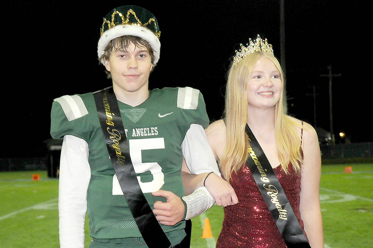 Port Angeles High School senior homecoming royalty King Parker Nickerson and Queen Paige Mason stand before an admiring crowd on Friday at halftime of the school’s football game against Bainbridge at Port Angeles Civic Field. (Keith Thorpe/Peninsula Daily News)