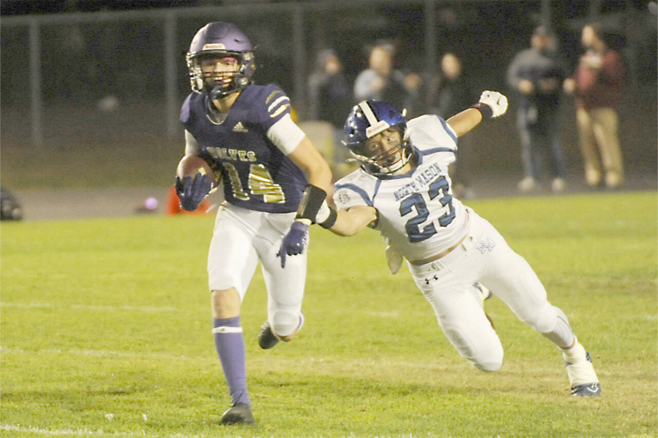 Sequim's Zeke Schmadeke runs for a gain against North Mason on Friday night. Schmadeke had a 60-yard punt return for a touchdown in the Wolves' 36-0 win. (Michael Dashiell/Olympic Peninsula News Group)