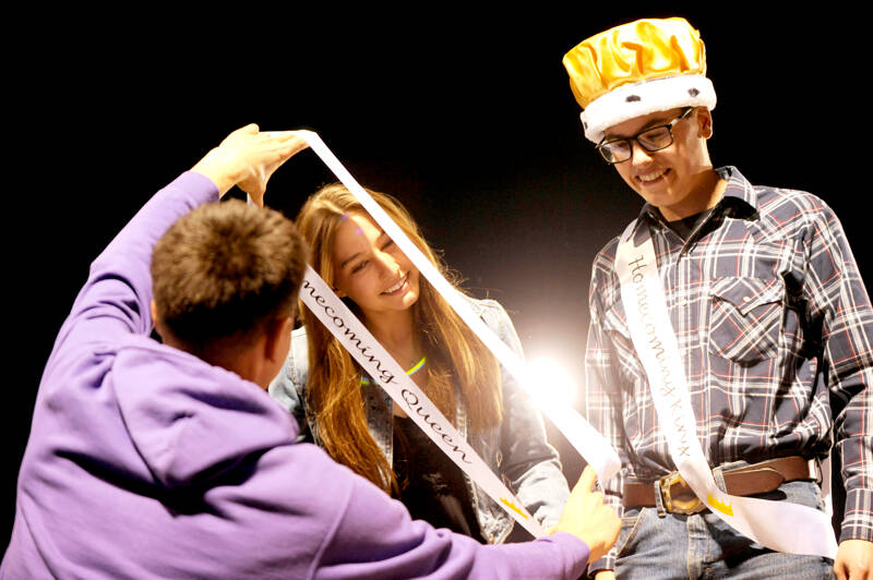 Sequim High School Homecoming Queen Taryn Johnson, left, receives a sash at Friday night’s football game while king Sage Younger looks on. Sequim shut out North Mason 36-0. (Michael Dashiell/Olympic Peninsula News Group)